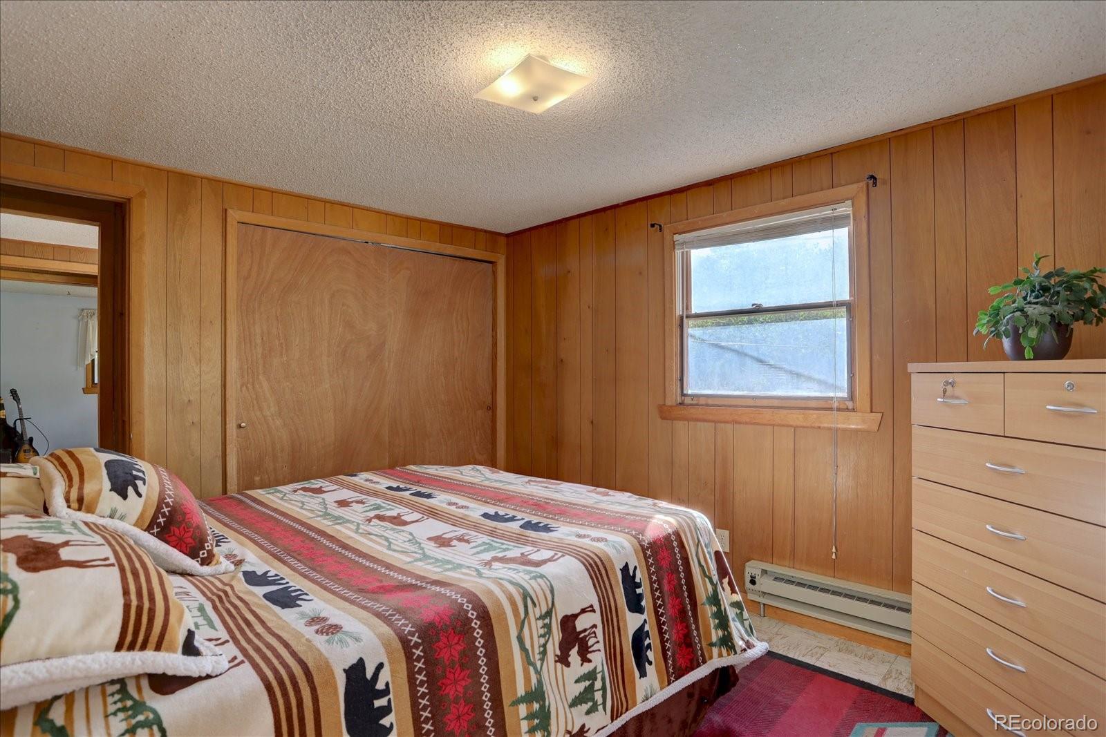 255 Saddlestring Road Bailey, CO 80421 - Photo 15 of 49 a bedroom with a bed and a window