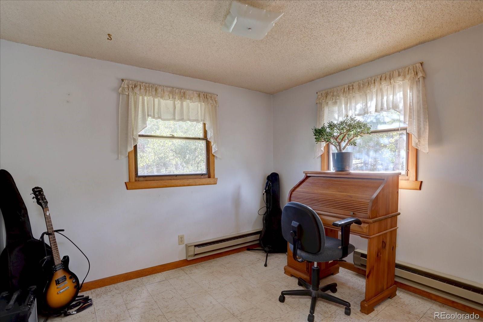 255 Saddlestring Road Bailey, CO 80421 - Photo 19 of 49 a view of a workspace with furniture and a window