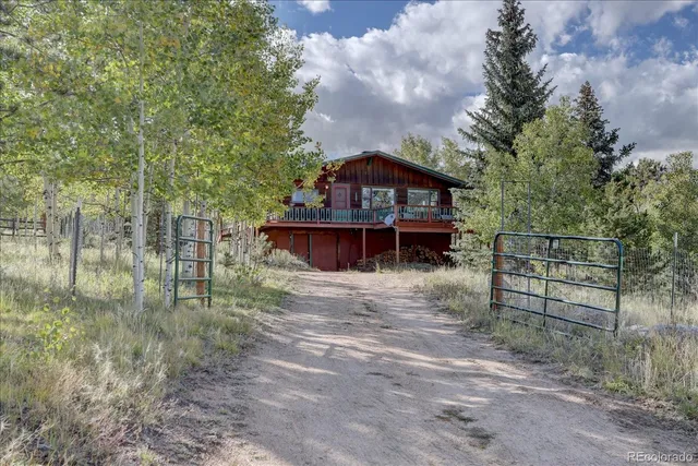 a view of a wooden house with a yard