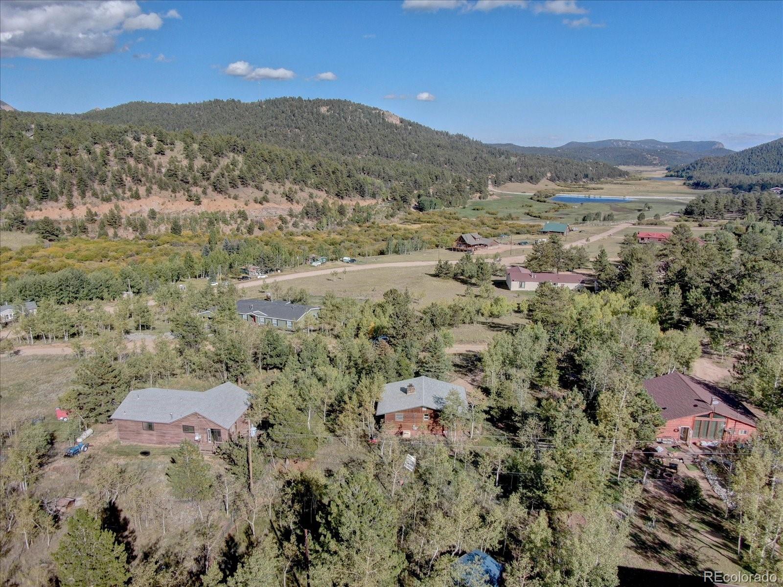 255 Saddlestring Road Bailey, CO 80421 - Photo 46 of 49 a view of a city with mountains in the background