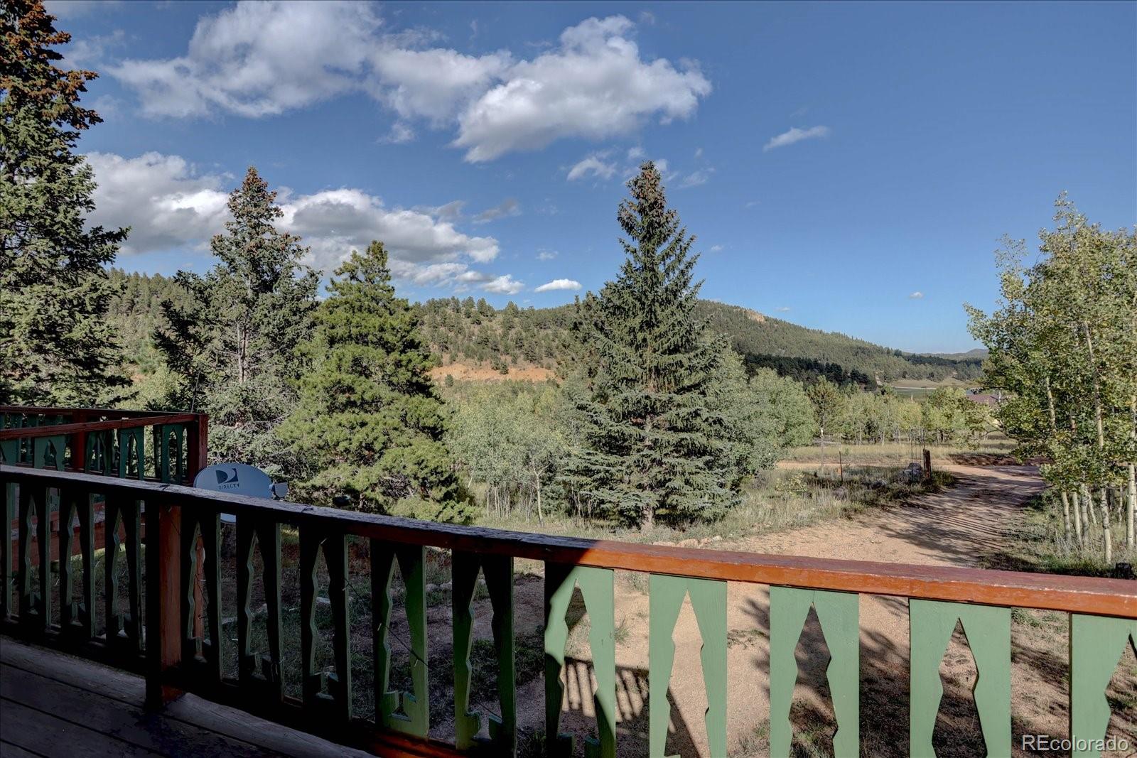 255 Saddlestring Road Bailey, CO 80421 - Photo 6 of 49 a balcony with trees in the back yard