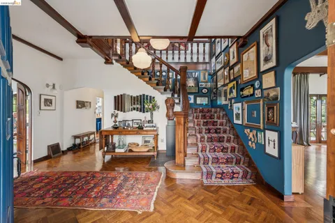 a living room with furniture fireplace and a large window