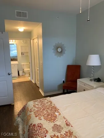 a bedroom with a bed and a lamp