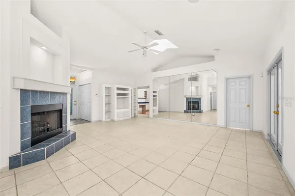 a view of an empty room with a fireplace