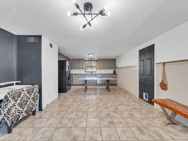 a living room with a couch and a chandelier
