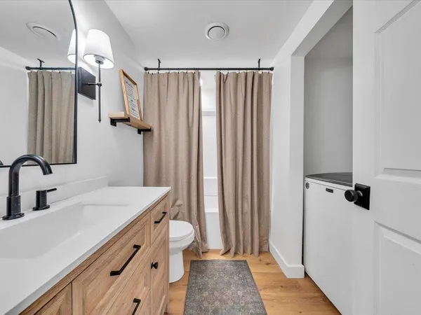 a bathroom with a double vanity sink and a mirror