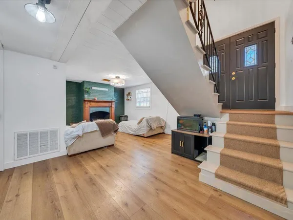 a living room with furniture and a wooden floor