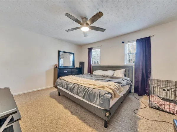 a bedroom with a bed and window