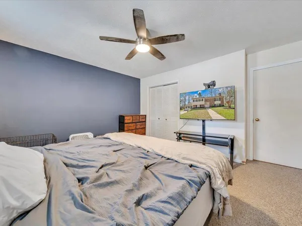 a bedroom with a bed and a chandelier