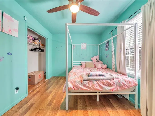 a bed room with a bed and a chandelier