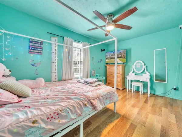 a bedroom with a bed window and a table