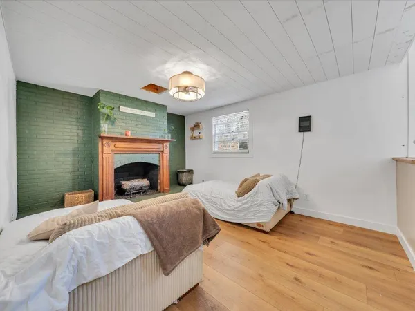 a bedroom with a bed and a fireplace