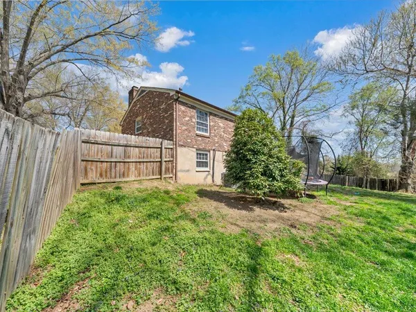 a view of a house with a small yard and plants