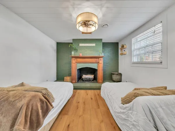 a bedroom with a bed and a fireplace