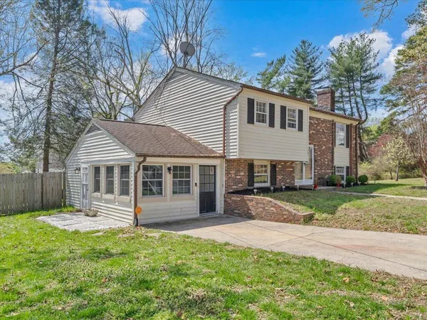 a front view of a house with a yard and fence