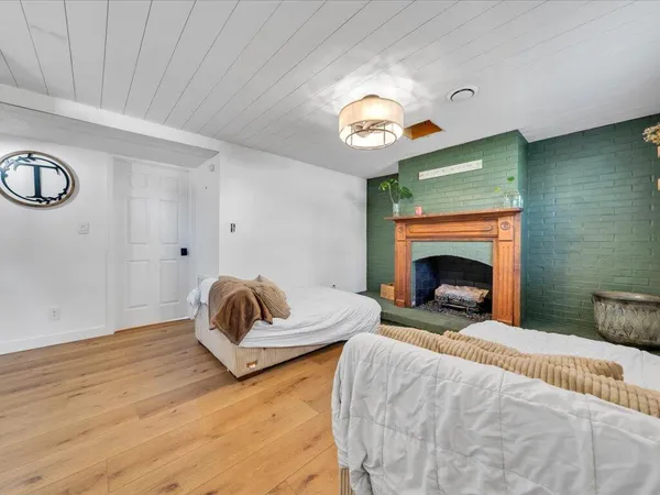 a bedroom with a bed and a fireplace