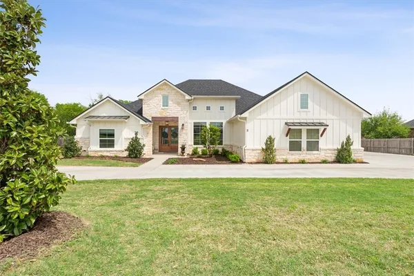 a front view of a house with a garden and porch