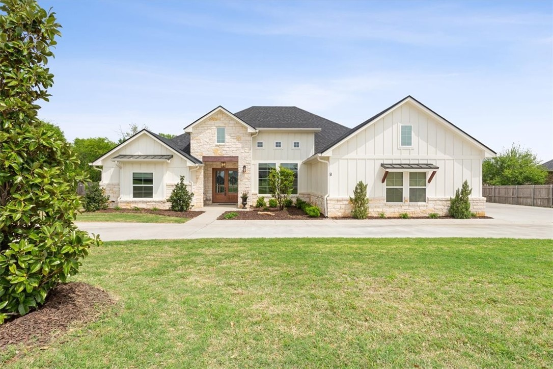 a front view of a house with a garden and porch