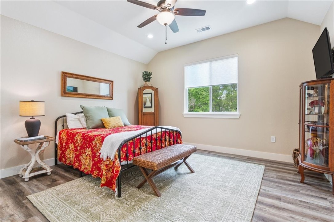 8 Independence Trail Waco, TX 76708 - Photo 25 of 39 a spacious bedroom with a bed and a flat screen tv
