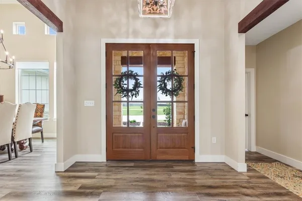 a view of a dining room with furniture wooden floor and chandelier