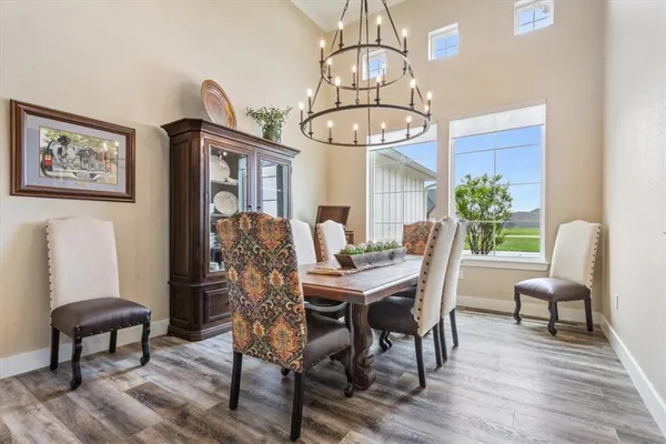 a living room with furniture kitchen view and a chandelier