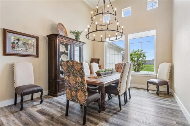 a living room with furniture kitchen view and a chandelier