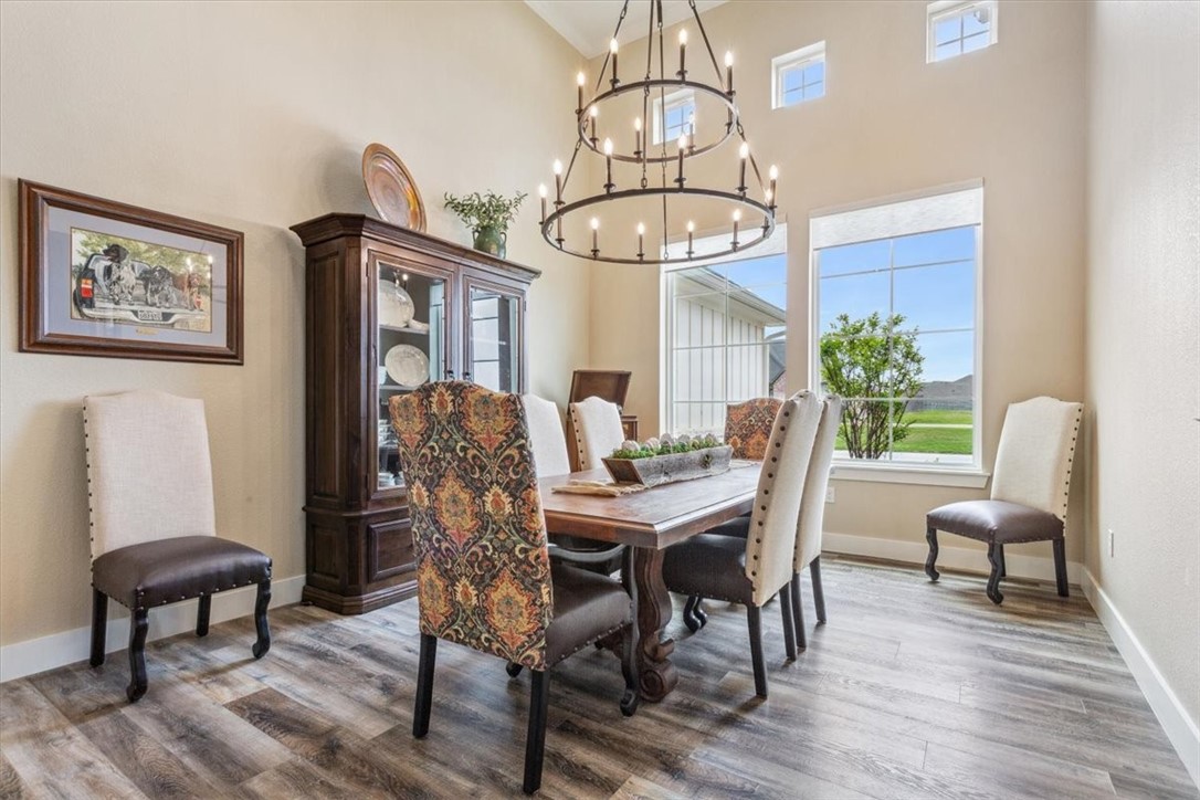 8 Independence Trail Waco, TX 76708 - Photo 6 of 39 a view of a dining room with furniture wooden floor and chandelier