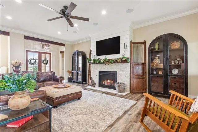 a living room with furniture a flat screen tv and a fireplace