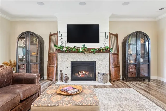a living room with furniture fireplace and a flat screen tv