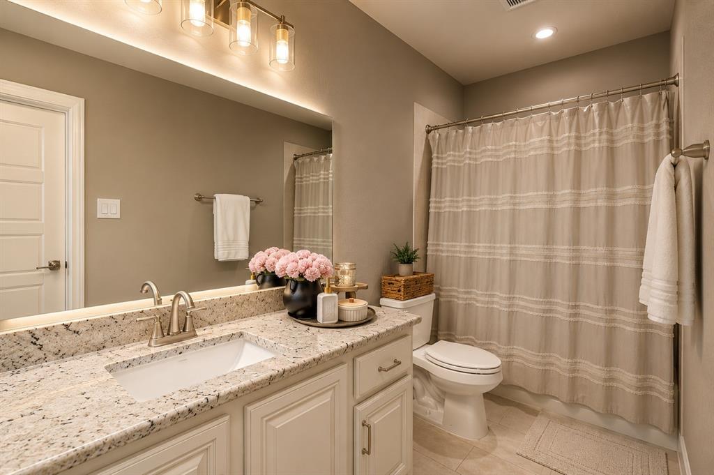 25 Morrison Road Howe, TX 75459 - Photo 12 of 27 Bathroom featuring a single vanity with a light-toned countertop, an undermount sink, and a brushed nickel faucet