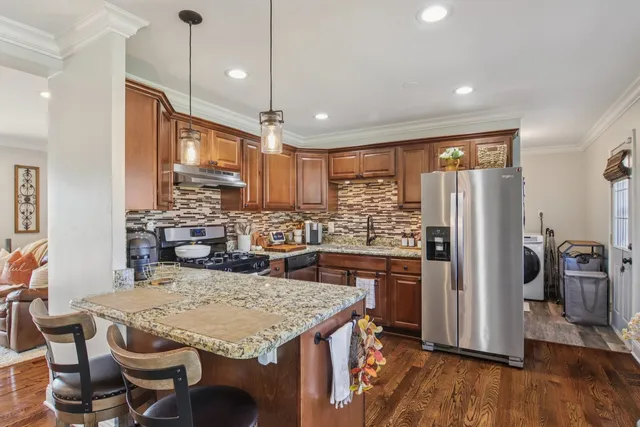 a kitchen with a table chairs refrigerator and microwave