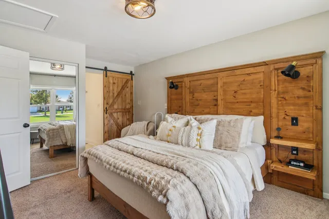 a bedroom with a large bed and a window