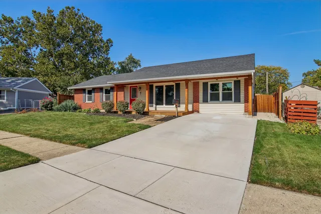 a view of a house with a backyard