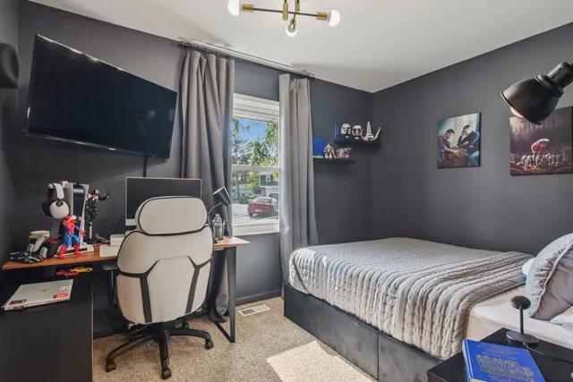 a bedroom with a bed and a flat screen tv