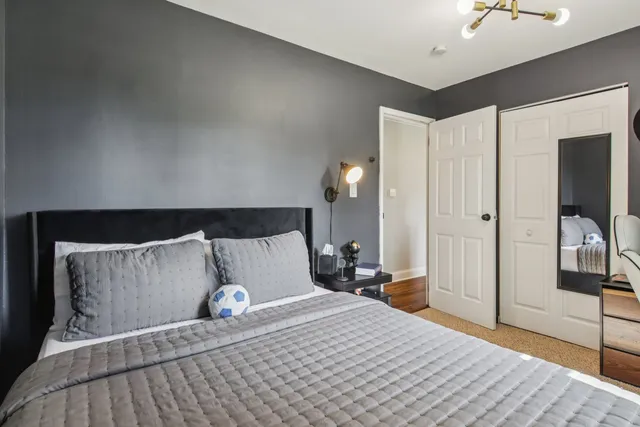 a bedroom with a bed and a mirror