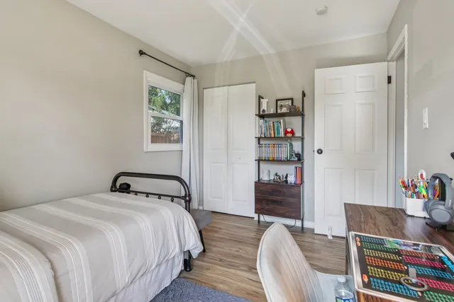 a bedroom with a bed and a window