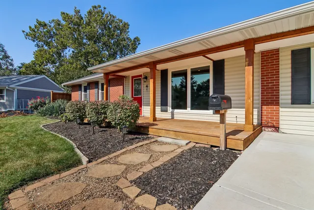a front view of a house with garden