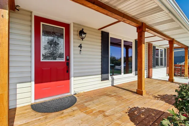 a view of porch with red door