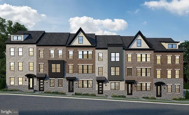 a front view of a residential apartment building with a yard