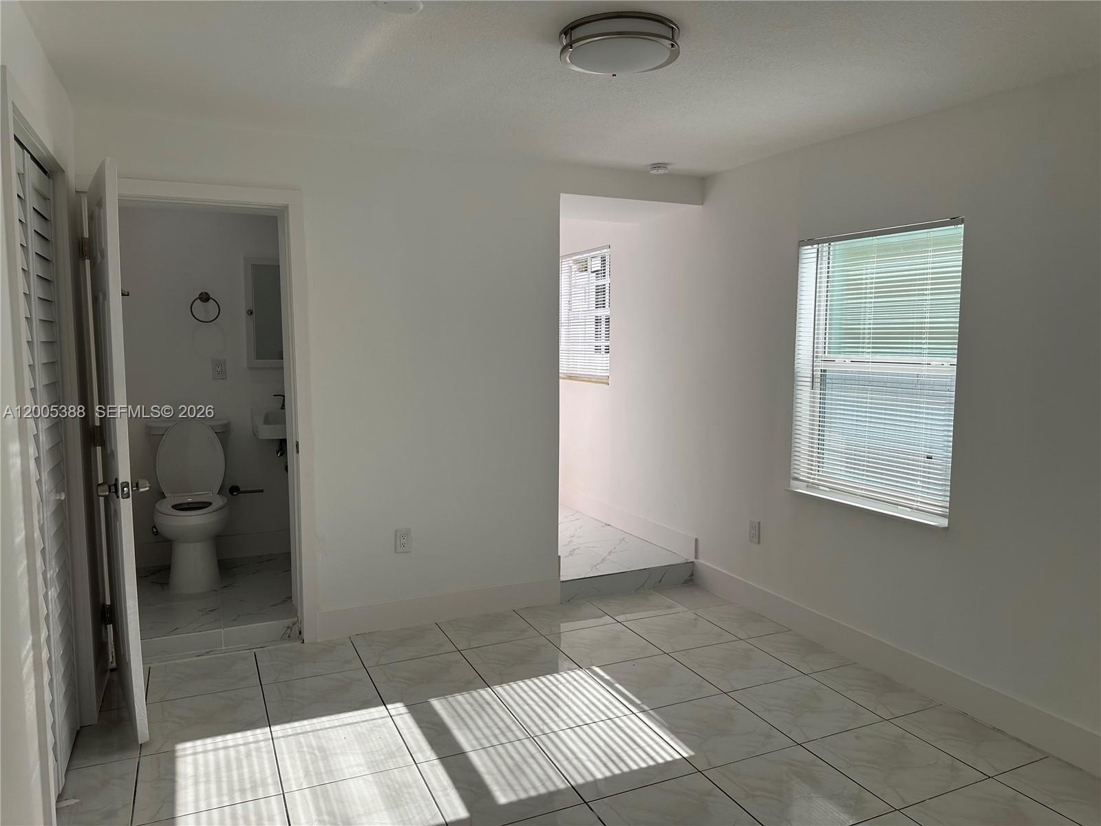 1765 Southwest 21st Street, Unit 3 Miami, FL 33145 - Photo 11 of 15 a bathroom with a toilet and a shower