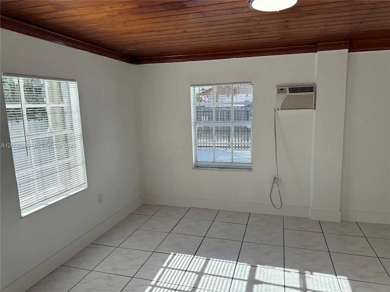 1765 Southwest 21st Street, Unit 3 Miami, FL 33145 - Photo 12 of 15 a view of an empty room with windows
