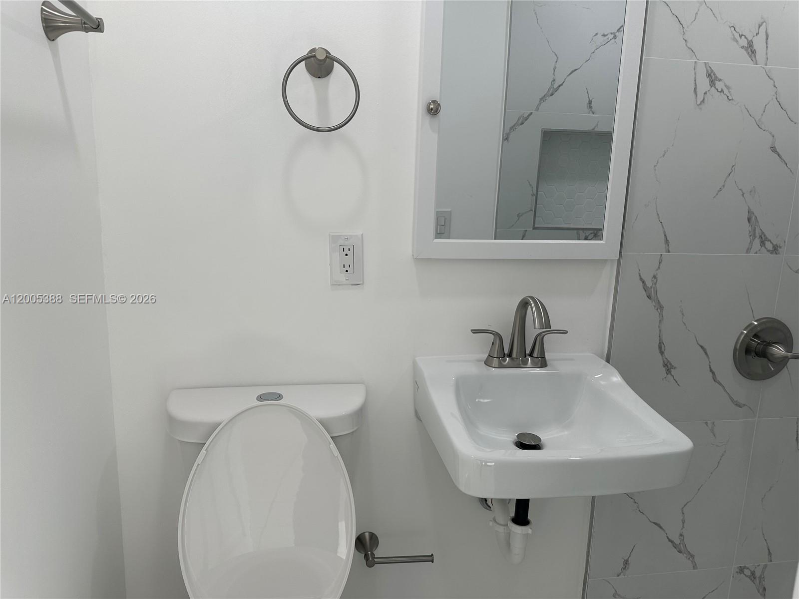 1765 Southwest 21st Street, Unit 3 Miami, FL 33145 - Photo 7 of 15 a bathroom with a sink a toilet and a mirror