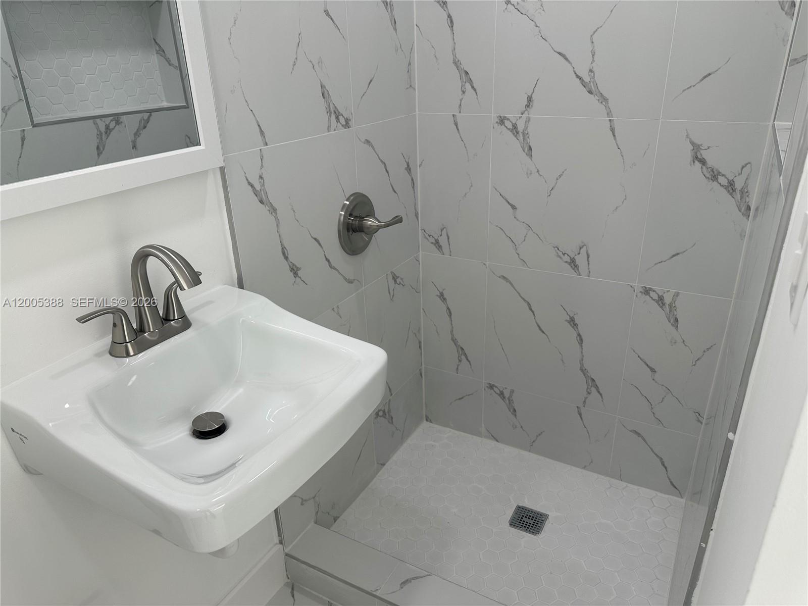 1765 Southwest 21st Street, Unit 3 Miami, FL 33145 - Photo 9 of 15 a bathroom with a sink and shower