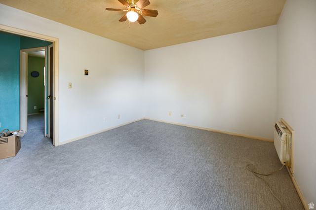 285 West 600 North, Unit 2 Logan, UT 84321 - Photo 12 of 21 Spacious interior room featuring light gray carpeting, white walls, and a ceiling fan with integrated lighting