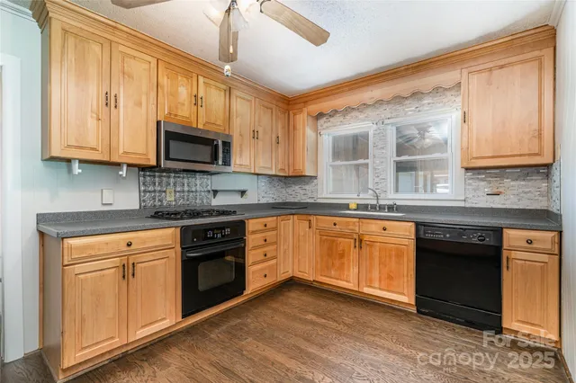 a kitchen with stainless steel appliances granite countertop a stove sink microwave and cabinets