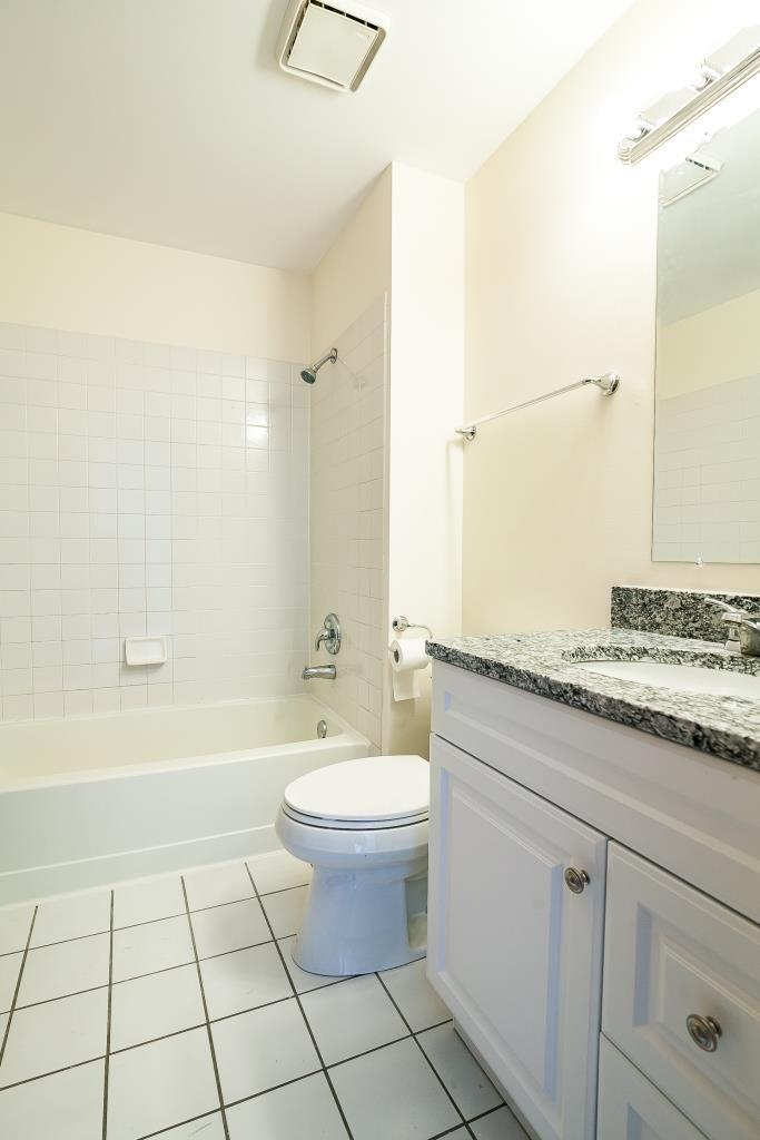 109 South Southport Road Mundelein, IL 60060 - Photo 12 of 16 a bathroom with a granite countertop sink a toilet and a bathtub