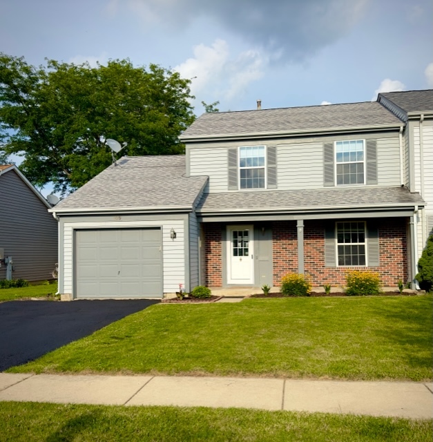 109 South Southport Road Mundelein, IL 60060 - Photo 2 of 16 a front view of a house with a yard and garage
