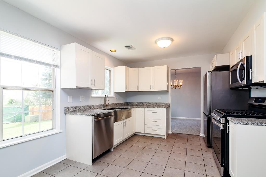 109 South Southport Road Mundelein, IL 60060 - Photo 3 of 16 a kitchen with a stove a sink and a refrigerator