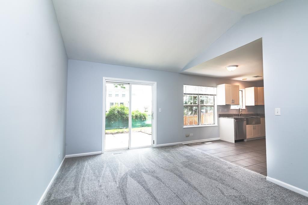 109 South Southport Road Mundelein, IL 60060 - Photo 8 of 16 wooden floor in an empty room with a kitchen