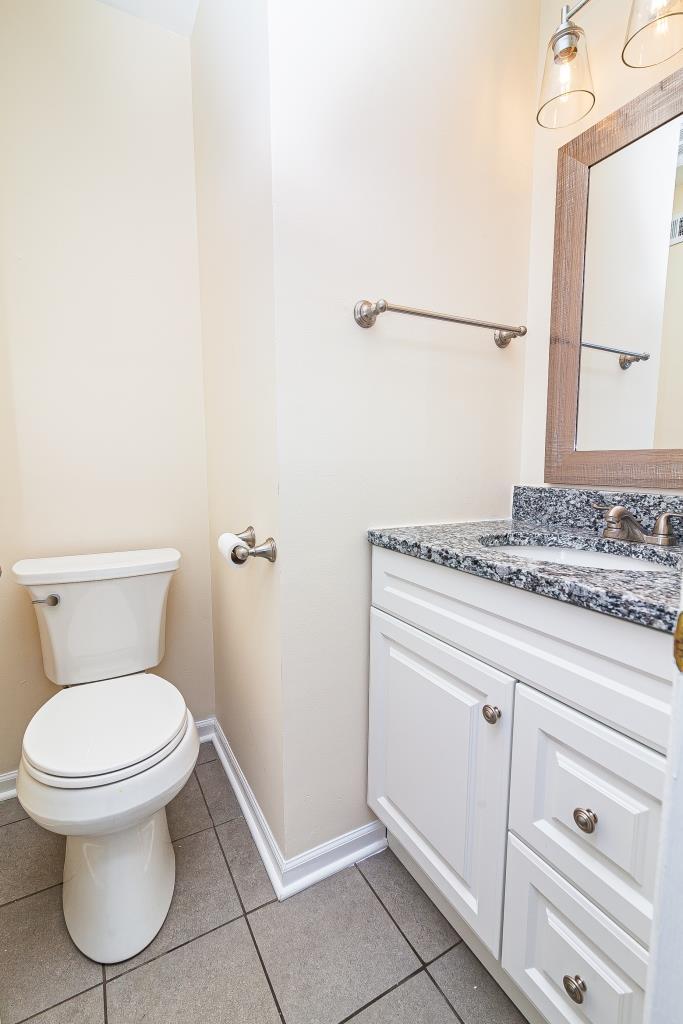 109 South Southport Road Mundelein, IL 60060 - Photo 9 of 16 a bathroom with a granite countertop toilet and a sink